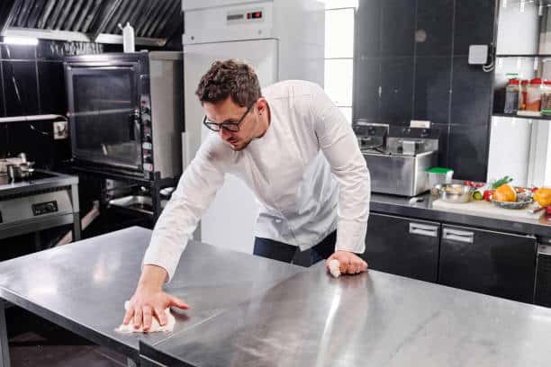 Efficient Kitchen Cleaning and Culinary Activity in a Bustling Restaurant