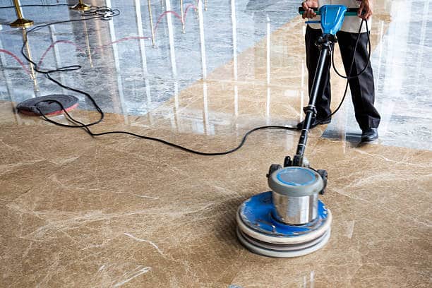 Man Effortlessly Doing Floor Cleaning, Revitalizing Polished Marble Surface with Precision