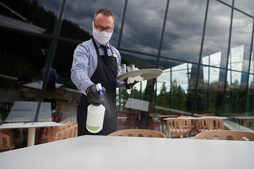 lively ambiance of an outdoor restaurant, vigilant hygiene takes center stage. A hospitality cleaning staff ensures tables are pristine,