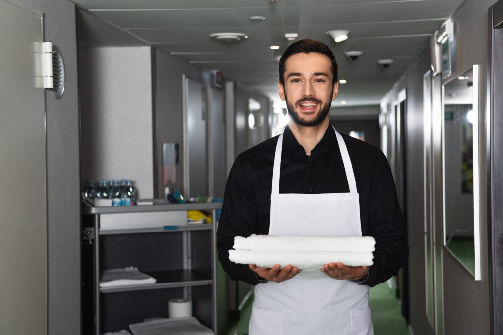 Smiling Commercial Cleaner ,And,Bearded,Housekeeper,Holding,White,Clean,Bed,Sheets