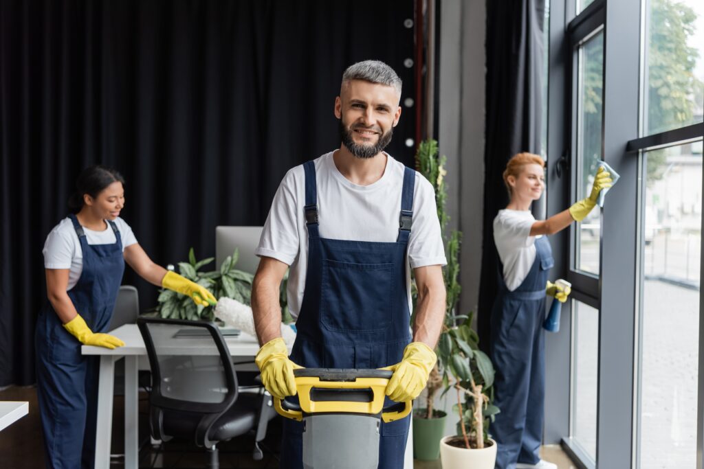 Happy,Man,With,Floor,Scrubber,Machine,Looking,At,Camera,Near